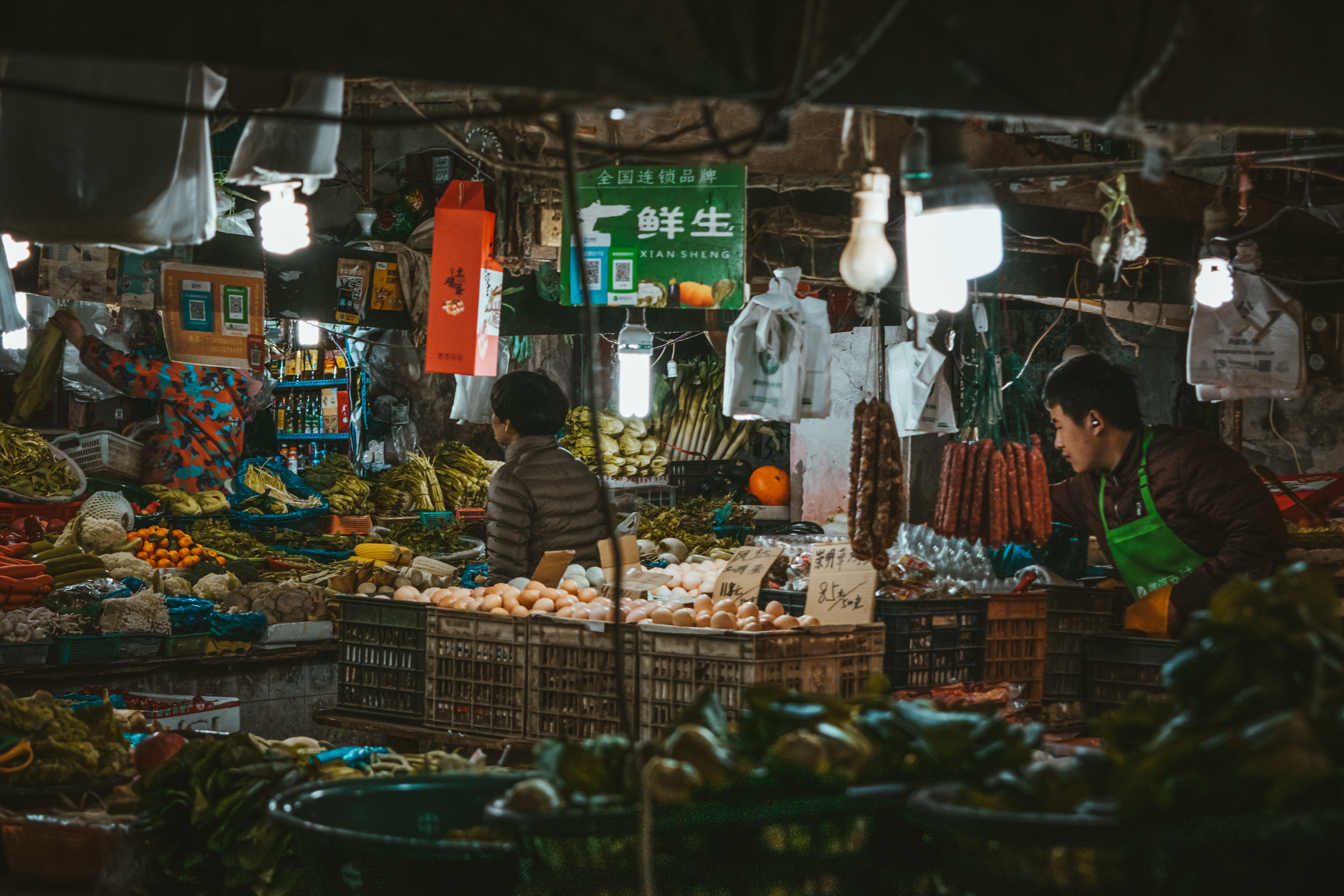 market vendors selling food and clothing in a market